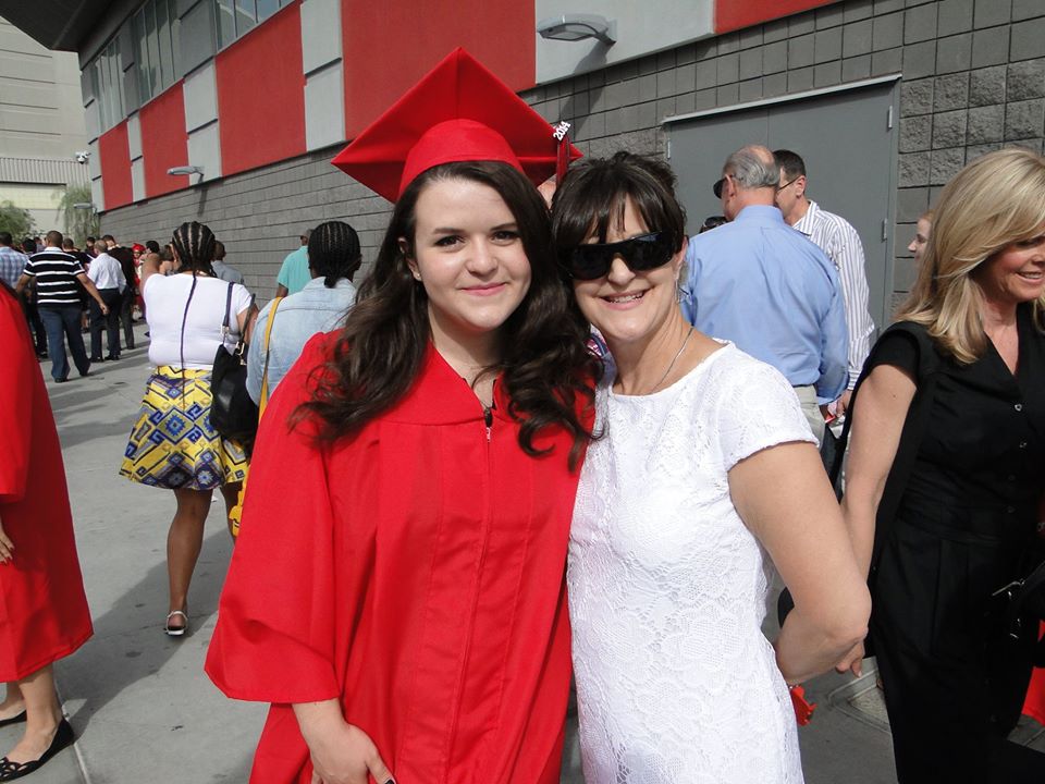 Jo in a red graduation gown with her mother