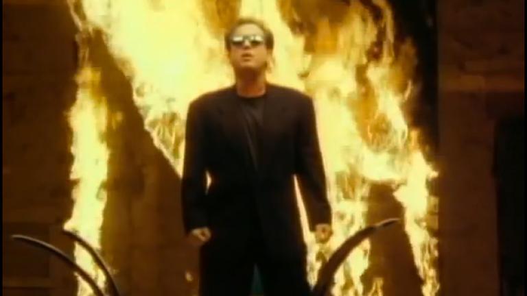 Billy Joel in front of a wall of fire