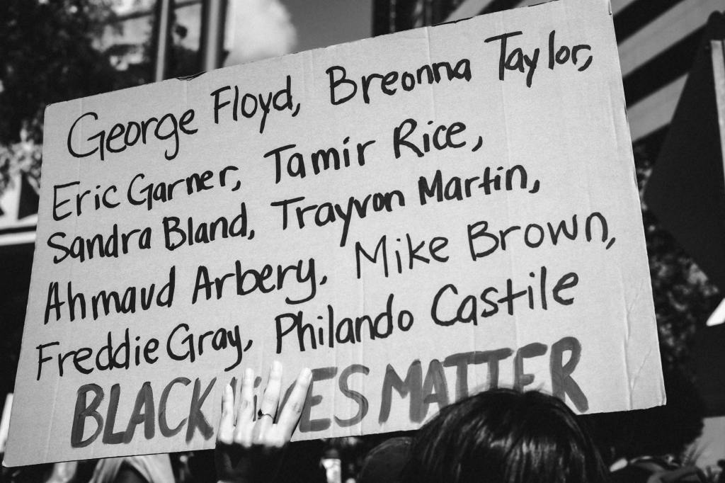 Protest sign listing the names of murdered black Americans