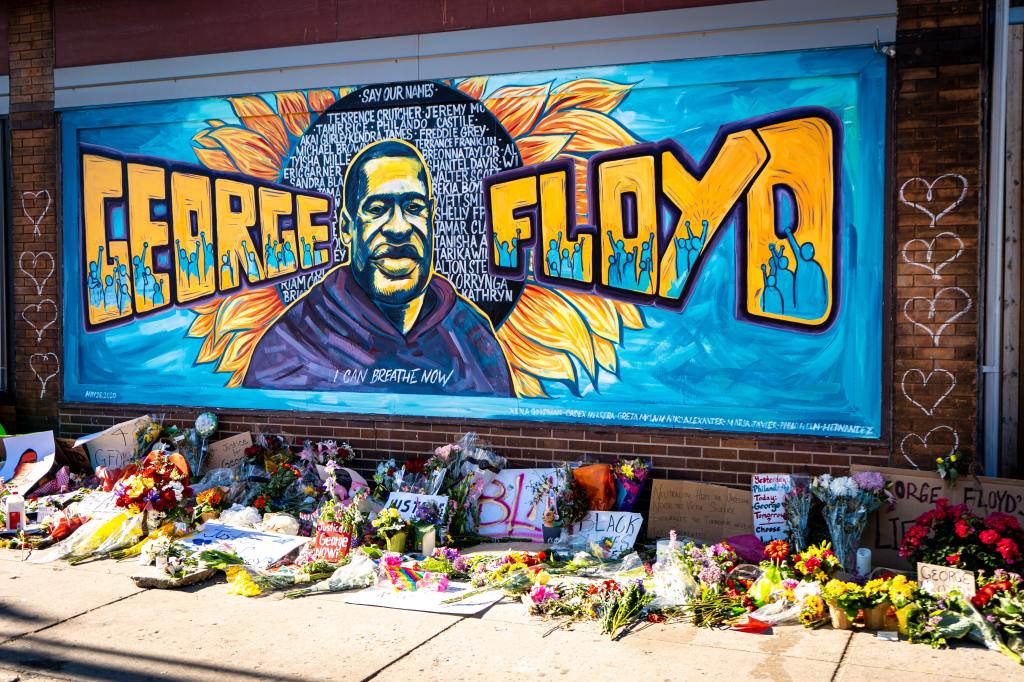Mural depicting George Floyd with flowers and tributes
