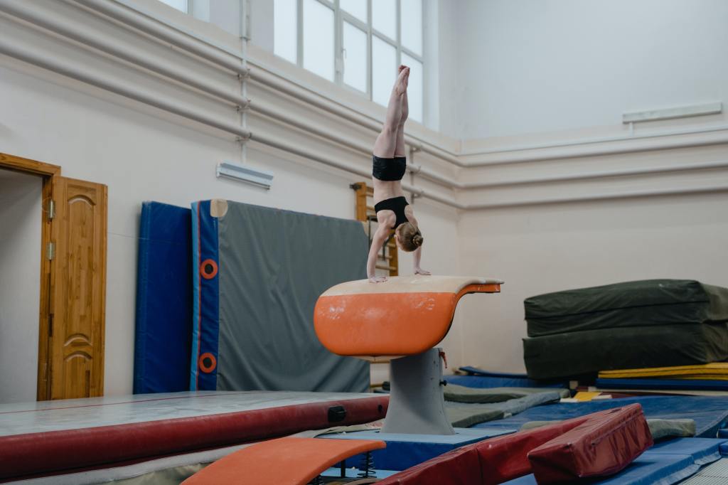 A female gymnast doing a handstand.